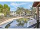 Outdoor pool area with brick patio, black fence and green lush trees at 4829 W San Miguel St, Tampa, FL 33629