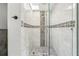 Stylish shower featuring mosaic tile accents, glass door and rainfall shower head at 4829 W San Miguel St, Tampa, FL 33629