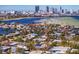 Aerial perspective of waterfront homes with solar panels and a city skyline in the background at 538 25Th Se Ave, St Petersburg, FL 33705