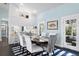 Bright dining room with white chairs, an oval wooden table, and access to a patio at 538 25Th Se Ave, St Petersburg, FL 33705