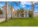 Two-story house with attached garage, lush lawn, and palm trees at 538 25Th Se Ave, St Petersburg, FL 33705