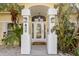Front entry with arched entryway, double columns, and glass door at 538 25Th Se Ave, St Petersburg, FL 33705