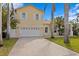 Two-car garage with white doors and light yellow exterior at 538 25Th Se Ave, St Petersburg, FL 33705