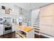 Bright kitchen features white cabinets, stainless steel appliances, and a wooden island at 538 25Th Se Ave, St Petersburg, FL 33705