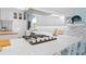 Modern white kitchen with quartz countertops, stainless steel appliances, and mosaic backsplash at 538 25Th Se Ave, St Petersburg, FL 33705