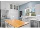 White kitchen with stainless steel appliances and a butcher block island at 538 25Th Se Ave, St Petersburg, FL 33705