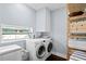Laundry room with washer, dryer, and built-in shelving at 538 25Th Se Ave, St Petersburg, FL 33705