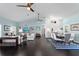 Open floor plan living space with hardwood floors, white sofas, and a kitchen island at 538 25Th Se Ave, St Petersburg, FL 33705