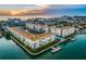 Beautiful aerial view of waterfront condo complex with pool and docks at sunset at 5575 Gulf Blvd # 425, St Pete Beach, FL 33706