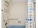 Bathroom featuring tiled walls, shower safety features, and decorative shower curtain at 5575 Gulf Blvd # 425, St Pete Beach, FL 33706