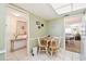 Charming dining area features wood table, adjacent to living area, and abundant natural light at 5575 Gulf Blvd # 425, St Pete Beach, FL 33706