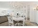 Elegant dining area with chandelier, white table, and mirrored accent wall at 5575 Gulf Blvd # 425, St Pete Beach, FL 33706