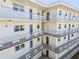 Exterior of condo building featuring walkways, balconies, and many entry doors at 5575 Gulf Blvd # 425, St Pete Beach, FL 33706