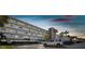 Exterior shot of the condo and parking lot during twilight at 5575 Gulf Blvd # 425, St Pete Beach, FL 33706