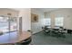 Bright and spacious community game room featuring tables, chairs, and a dartboard for resident enjoyment at 5575 Gulf Blvd # 425, St Pete Beach, FL 33706