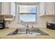 Kitchen area with a stainless steel sink with a window providing natural light at 5575 Gulf Blvd # 425, St Pete Beach, FL 33706
