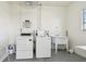 Laundry room with coin-operated washer, dryer, and utility sink at 5575 Gulf Blvd # 425, St Pete Beach, FL 33706