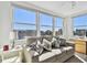 Bright living room featuring large windows and comfortable seating with water views at 5575 Gulf Blvd # 425, St Pete Beach, FL 33706