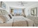 Bedroom features a large tufted headboard, neutral tones, and a dresser at 5575 Gulf Blvd # 425, St Pete Beach, FL 33706