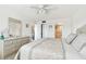 Bedroom features a large tufted headboard, neutral tones, and a dresser at 5575 Gulf Blvd # 425, St Pete Beach, FL 33706