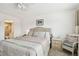 Bedroom features a large tufted headboard, neutral tones, and a dresser at 5575 Gulf Blvd # 425, St Pete Beach, FL 33706