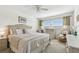 Bedroom features a large tufted headboard, neutral tones, and a dresser at 5575 Gulf Blvd # 425, St Pete Beach, FL 33706