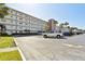 A view of the building exterior with palm trees and ample parking available at 5575 Gulf Blvd # 425, St Pete Beach, FL 33706