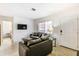 Comfortable living room featuring gray sofas and a modern TV at 6105 Antrim St, New Port Richey, FL 34653