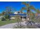 House exterior with solar panels, palm trees, and paved driveway at 783 Placido Ne Way, St Petersburg, FL 33704