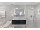 Modern bathroom with double sinks, marble tile, and glass shower at 900 31St Ne Ave, St Petersburg, FL 33704