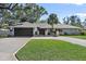 Updated single-story home with a large driveway and landscaped lawn at 900 31St Ne Ave, St Petersburg, FL 33704