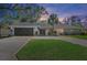 House exterior at dusk, showcasing landscaping and driveway at 900 31St Ne Ave, St Petersburg, FL 33704