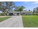 House exterior featuring a paved driveway and landscaped lawn at 900 31St Ne Ave, St Petersburg, FL 33704