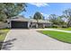 House exterior with paved driveway and landscaped lawn at 900 31St Ne Ave, St Petersburg, FL 33704