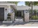 Elegant entryway with a wrought iron gate and stone pillars at 900 31St Ne Ave, St Petersburg, FL 33704