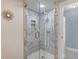 Clean shower with marble tile and glass enclosure at 900 31St Ne Ave, St Petersburg, FL 33704