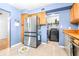 Kitchen with stainless steel appliances, laundry hookups, and wood cabinets at 9465 50Th N Way, Pinellas Park, FL 33782