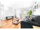 Bright living room with hardwood floors, a gray couch, and a coffee table at 9465 50Th N Way, Pinellas Park, FL 33782