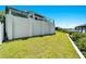 Landscaped backyard with lush green grass and waterfront views at 1024 Sonata Ln, Apollo Beach, FL 33572