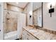 Modern bathroom with a tub, shower, and granite countertop at 1024 Sonata Ln, Apollo Beach, FL 33572