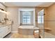 Spa-like bathroom featuring a soaking tub, walk-in shower, and mosaic tile at 1024 Sonata Ln, Apollo Beach, FL 33572
