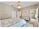 Bedroom with queen bed, private bath access, and built-in shelving at 1024 Sonata Ln, Apollo Beach, FL 33572