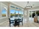 Open concept dining room with large chandelier and water views at 1024 Sonata Ln, Apollo Beach, FL 33572
