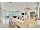 Bright dining area with a rustic wooden table and white chairs at 1024 Sonata Ln, Apollo Beach, FL 33572