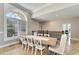 Elegant dining room with a large farmhouse table and a view at 1024 Sonata Ln, Apollo Beach, FL 33572