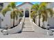 Elegant home exterior featuring grand staircase and lush landscaping at 1024 Sonata Ln, Apollo Beach, FL 33572