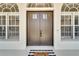 Double front doors with arched windows and welcome mat at 1024 Sonata Ln, Apollo Beach, FL 33572
