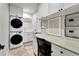 Bright laundry room with washer, dryer, and workspace at 1024 Sonata Ln, Apollo Beach, FL 33572