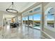 Open concept living room with water views and kitchen access at 1024 Sonata Ln, Apollo Beach, FL 33572