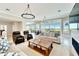 Spacious living room with large windows, fireplace and comfortable seating at 1024 Sonata Ln, Apollo Beach, FL 33572